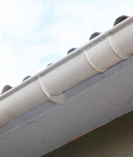 White plastic roof gutter pipeline with holders - Big Easy Gutter